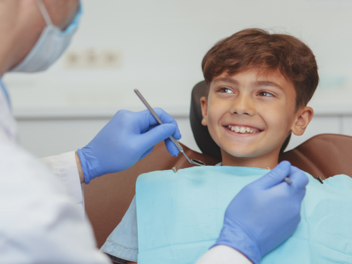 young boy smiling at dentist