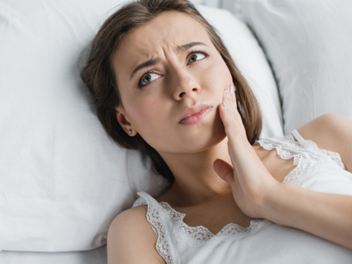 woman waking up with jaw pain