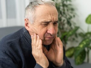 man suffering from jaw pain